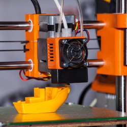 3D printer creating a 3D boat model, teaching kids about 3D printing technology and its applications in STEM workshops.