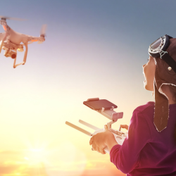 A kid piloting a drone during an aerospace and drone technology workshop for kids.